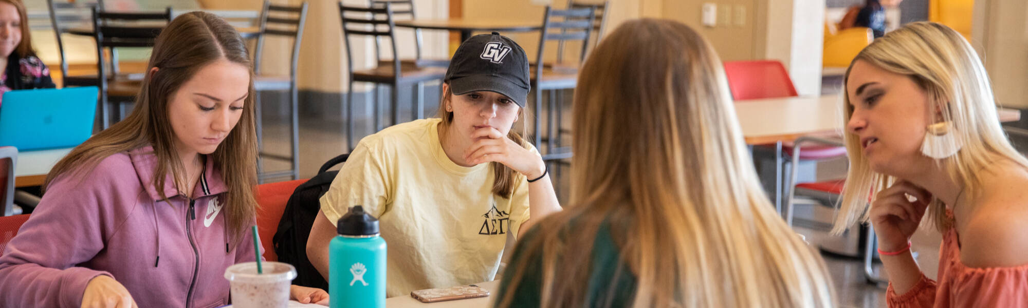 Four students working at a table together